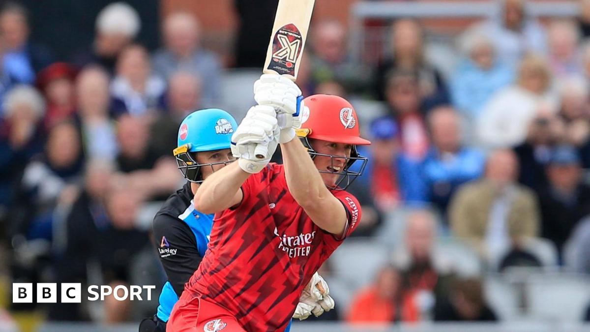 Keaton Jennings batting for Lancashire, with a full flourish of his bat, as the Worcestershire wicketkeeper watches on